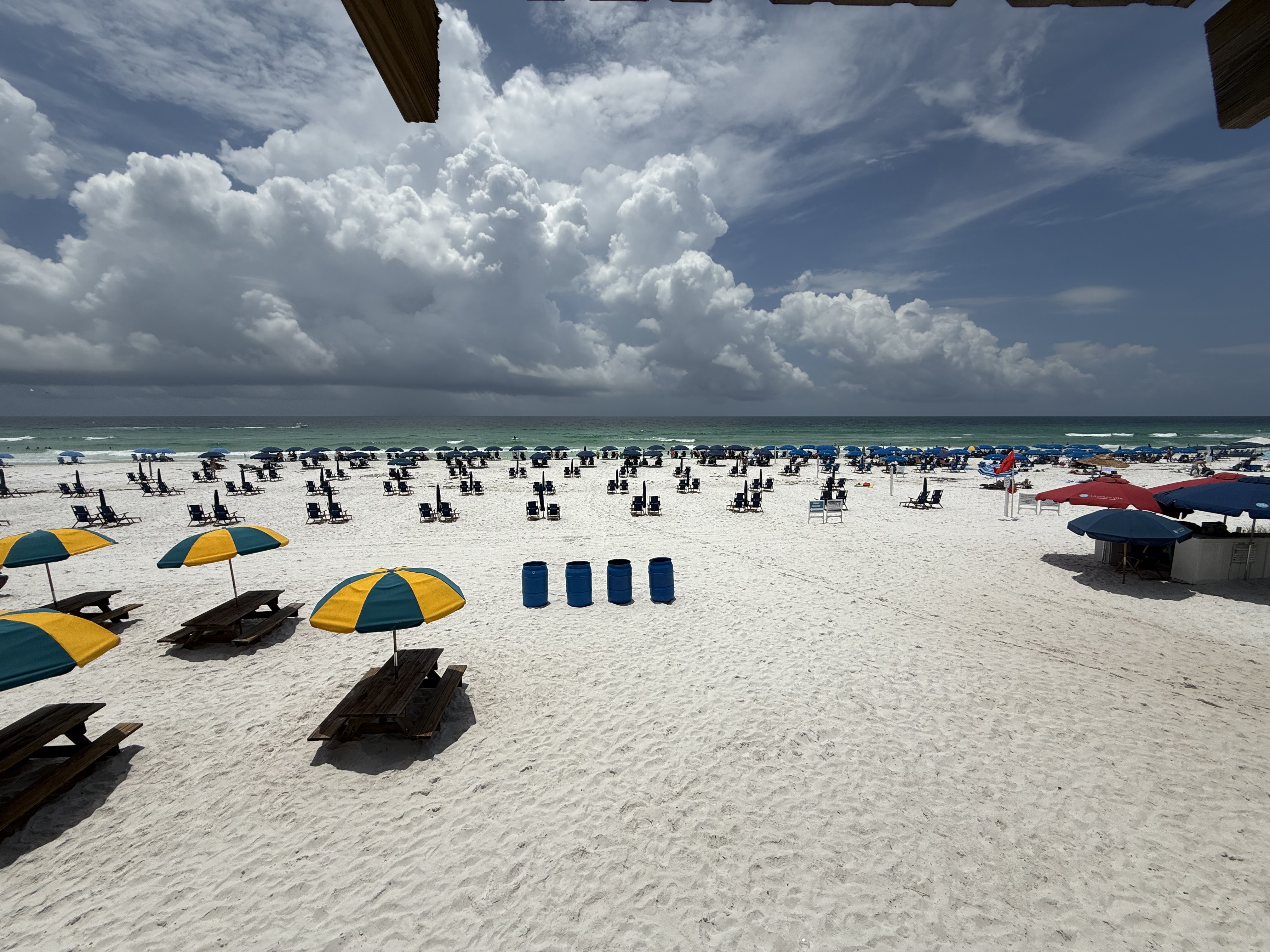 White sand beach with colorful umbrellas along 30A